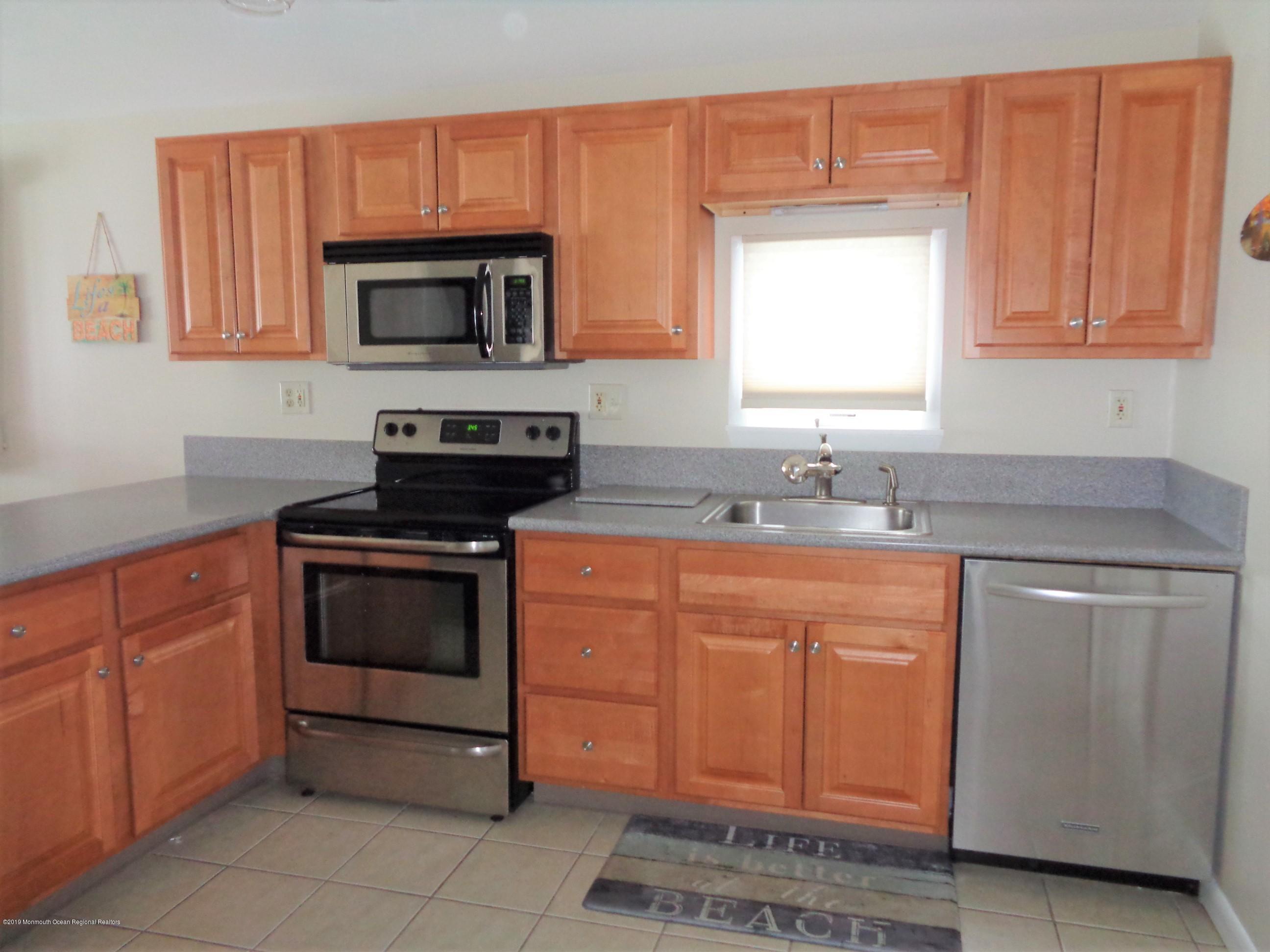 20 Capstan Road Waretown, NJ 08758 - Photo 9 of 25 a kitchen with stainless steel appliances granite countertop a stove a sink and a microwave