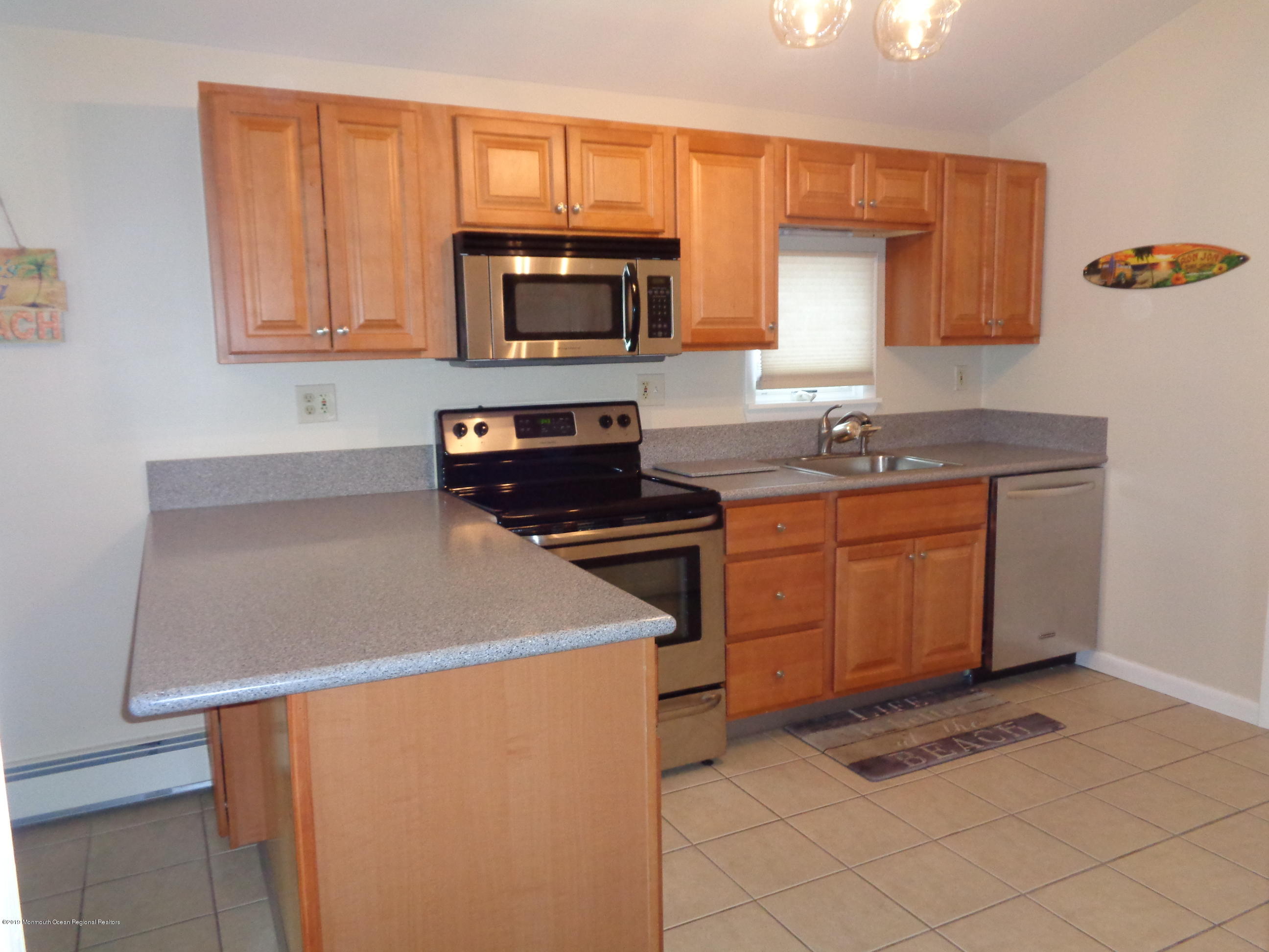 20 Capstan Road Waretown, NJ 08758 - Photo 10 of 25 a kitchen with stainless steel appliances granite countertop a stove a sink and a microwave