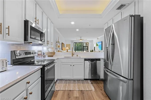 a kitchen with stainless steel appliances a refrigerator sink and microwave