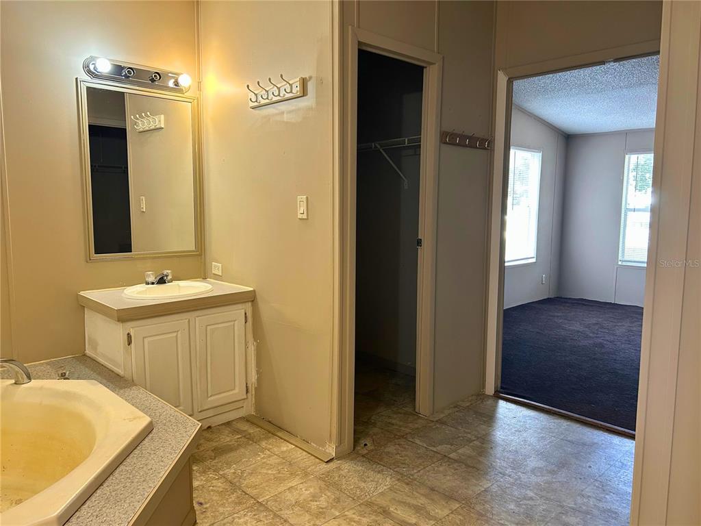 9867 Jerome Drive New Port Richey, FL 34654 - Photo 10 of 30 a bathroom with a granite countertop sink and a mirror