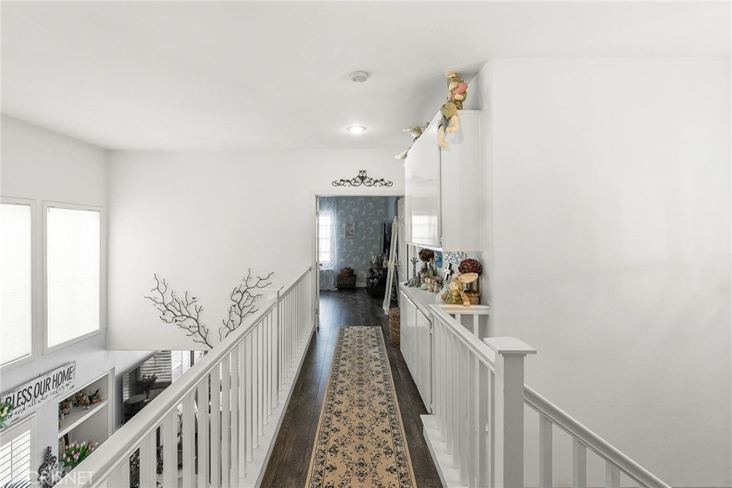 545 Lorabel Way, Unit D Simi Valley, CA 93065 - Photo 13 of 34 a view of a hallway with wooden floor and stairs