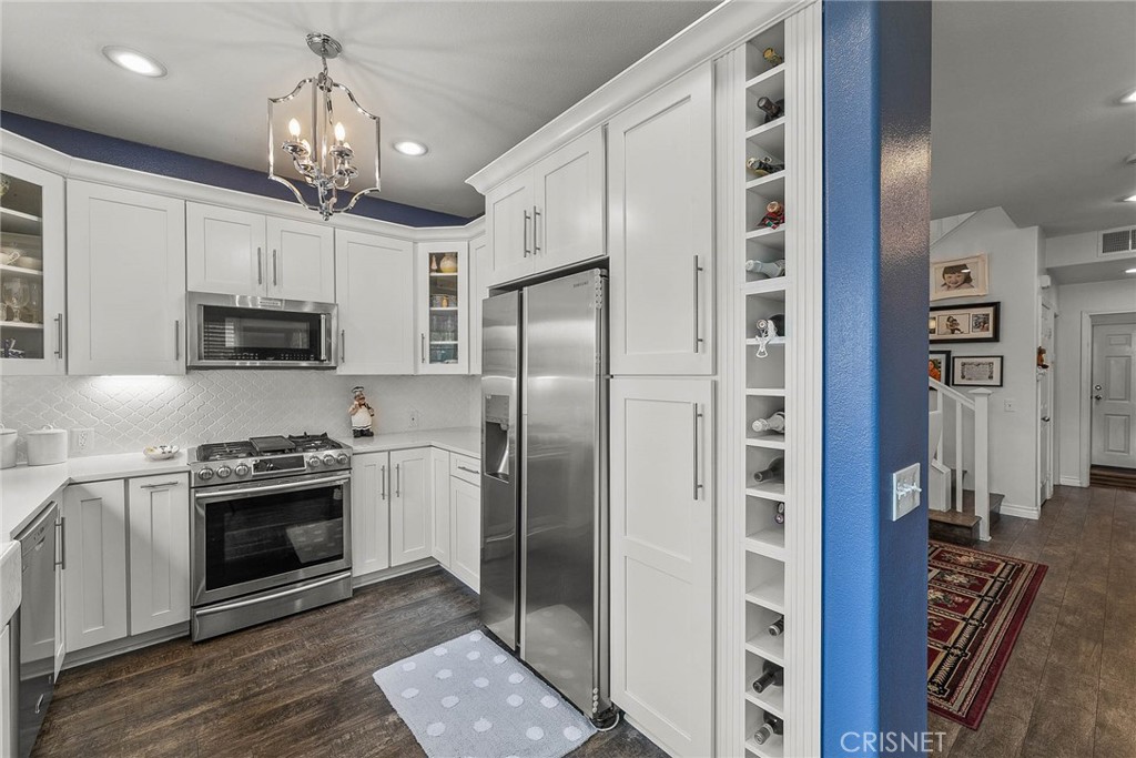 545 Lorabel Way, Unit D Simi Valley, CA 93065 - Photo 15 of 34 a kitchen with stainless steel appliances granite countertop a refrigerator and a stove top oven