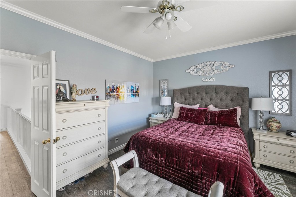 545 Lorabel Way, Unit D Simi Valley, CA 93065 - Photo 25 of 34 a bedroom with a bed and a chandelier