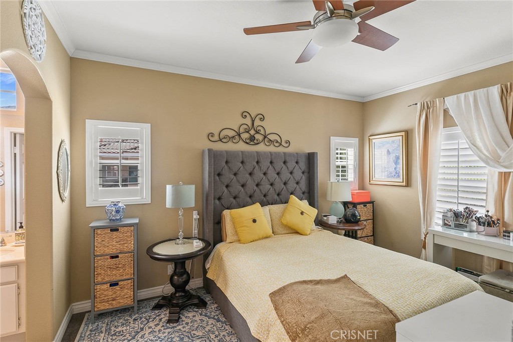 545 Lorabel Way, Unit D Simi Valley, CA 93065 - Photo 27 of 34 a bedroom with a bed and wooden floor