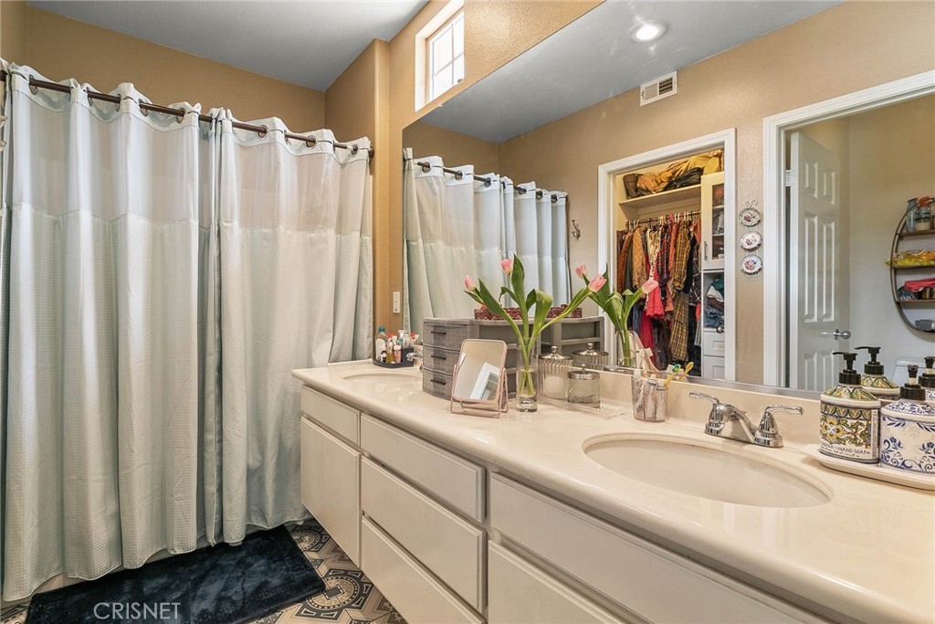 545 Lorabel Way, Unit D Simi Valley, CA 93065 - Photo 29 of 34 a bathroom with a double vanity sink and a mirror