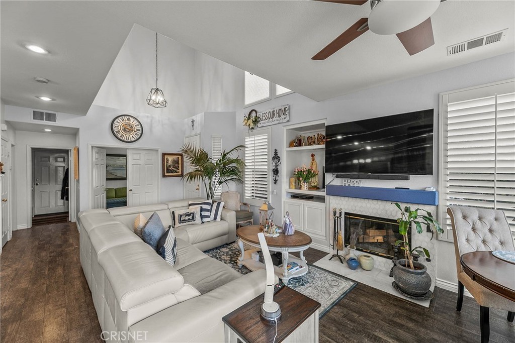 545 Lorabel Way, Unit D Simi Valley, CA 93065 - Photo 5 of 34 a living room with furniture a fireplace and a flat screen tv
