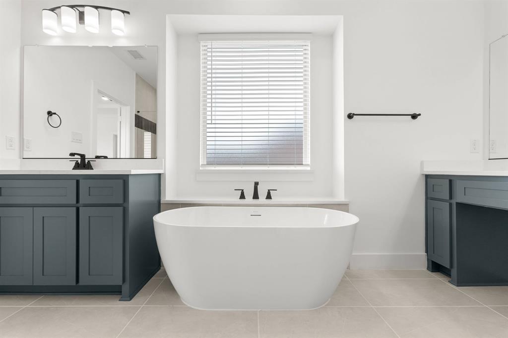 413 Tower Street DeSoto, TX 75115 - Photo 23 of 30 a white bath tub sitting in a bathroom