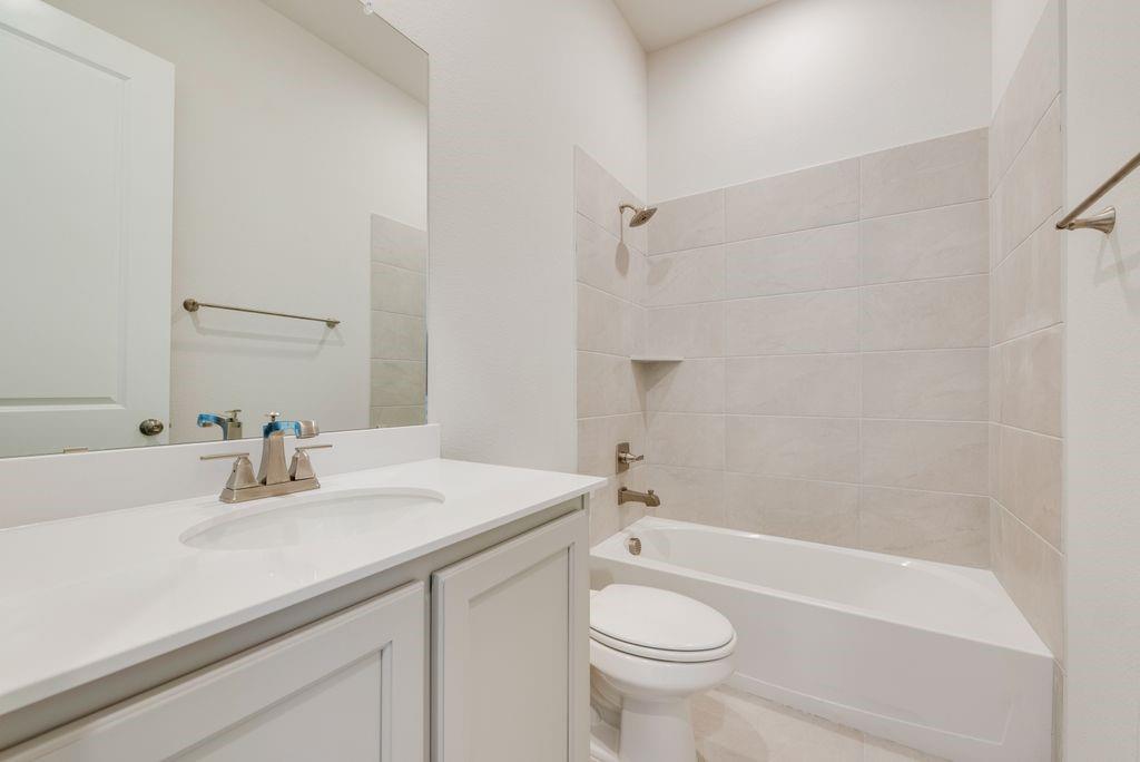 418 Bassett Hall Road Fate, TX 75189 - Photo 20 of 32 a bathroom with a sink a toilet and shower