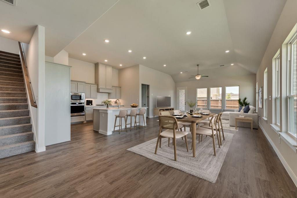 418 Bassett Hall Road Fate, TX 75189 - Photo 27 of 32 a view of a dining room with furniture and wooden floor