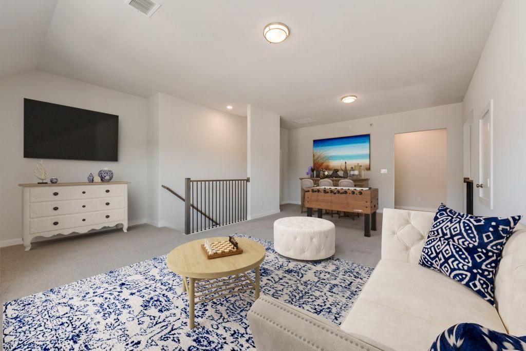 418 Bassett Hall Road Fate, TX 75189 - Photo 30 of 32 a living room with furniture and a flat screen tv