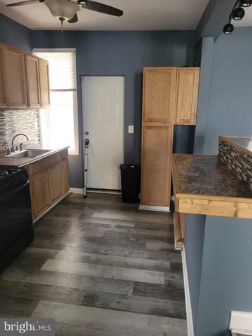 a kitchen with granite countertop a refrigerator and a sink