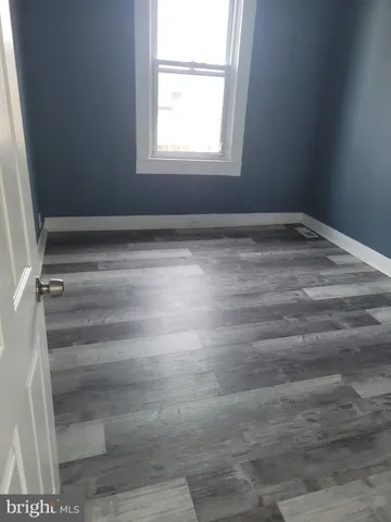 a view of a room with rack and a window