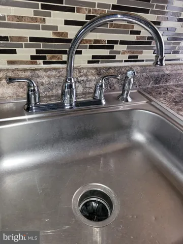 a bathroom with a sink toilet and a mirror
