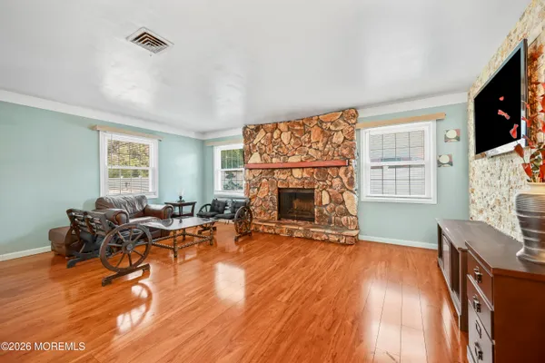 a living room with furniture a fireplace and a flat screen tv