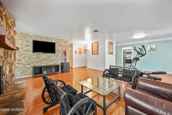 a living room with furniture a fireplace and a flat screen tv