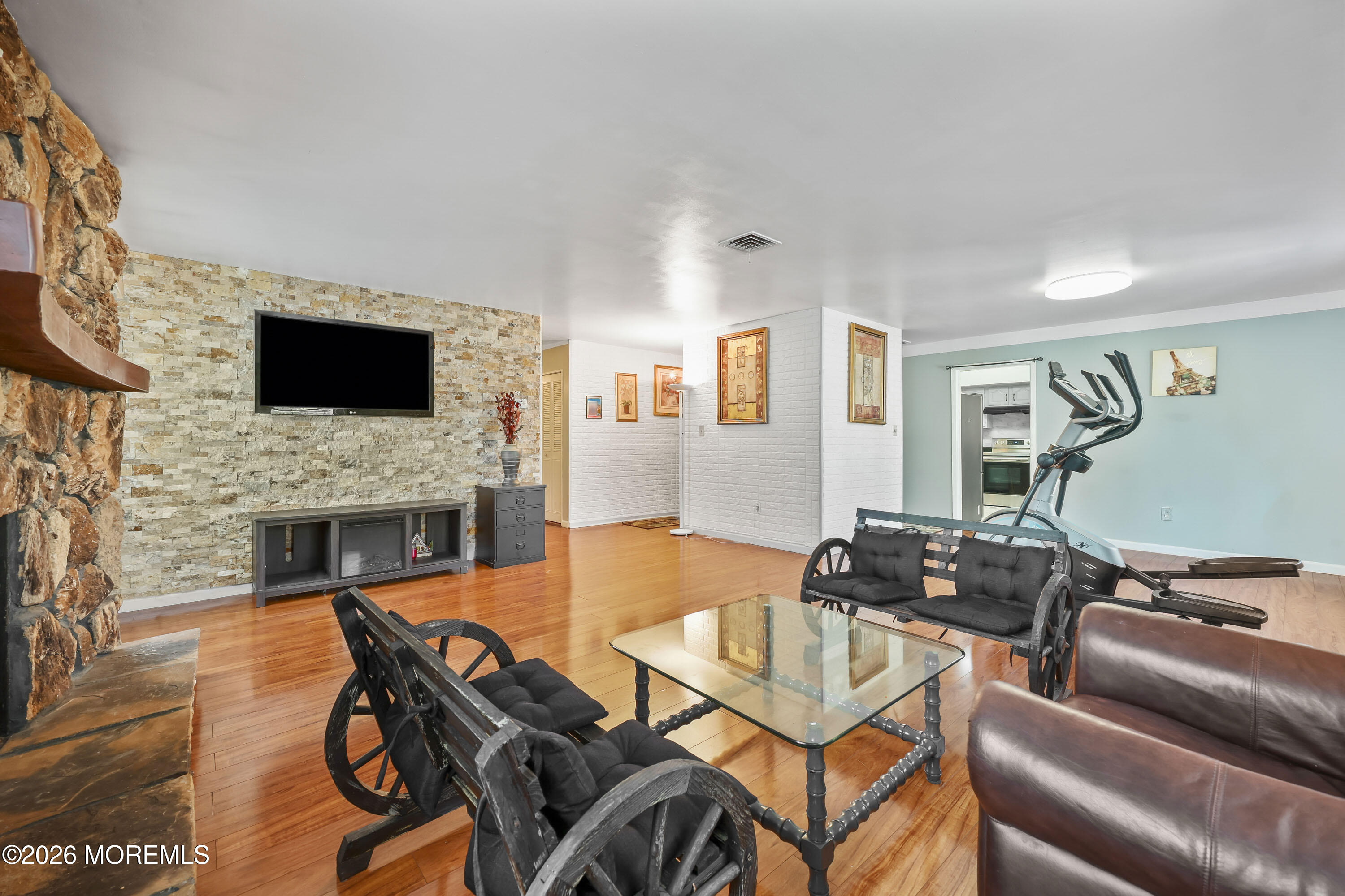 287 Church Street Aberdeen, NJ 07747 - Photo 5 of 15 a living room with furniture a fireplace and a flat screen tv
