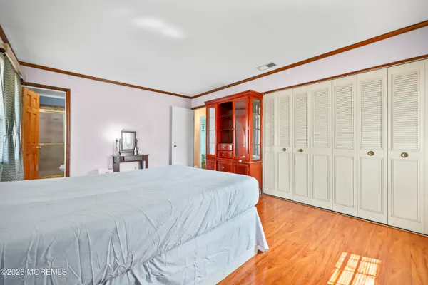 a bed room with a bed and a large mirror