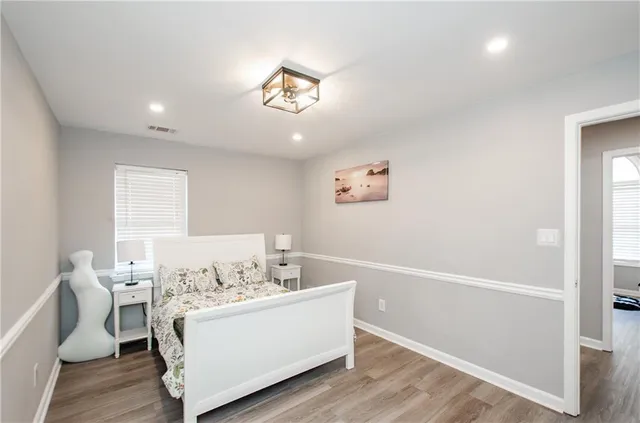 a view of a room with furniture and wooden floor
