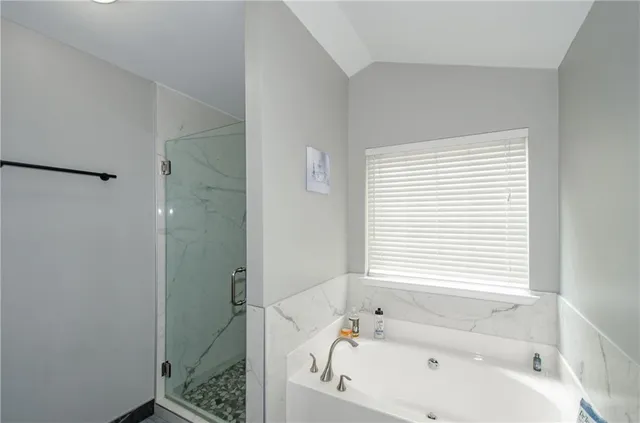 a bathroom with a bathtub and a shower