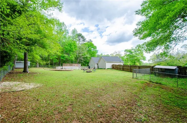 a view of a backyard with a garden and trees