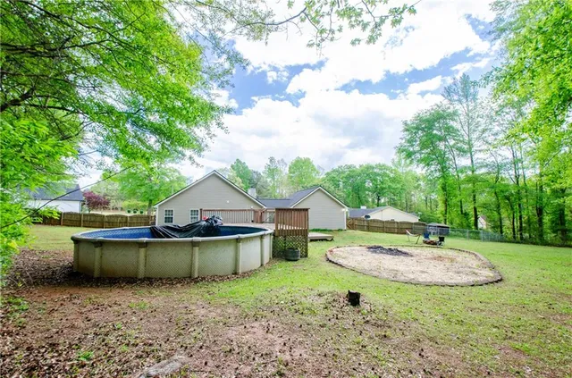 a backyard of a house with table and chairs