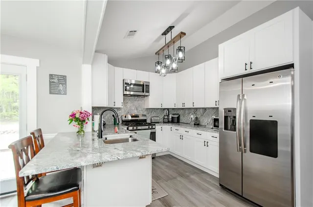 a kitchen with a refrigerator and a sink