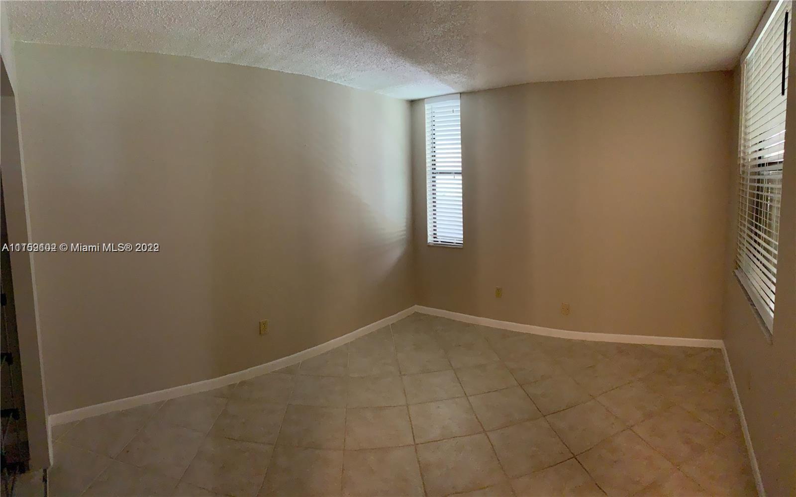 6800 Cypress Road, Unit 208 Plantation, FL 33317 - Photo 11 of 13 an empty room with windows