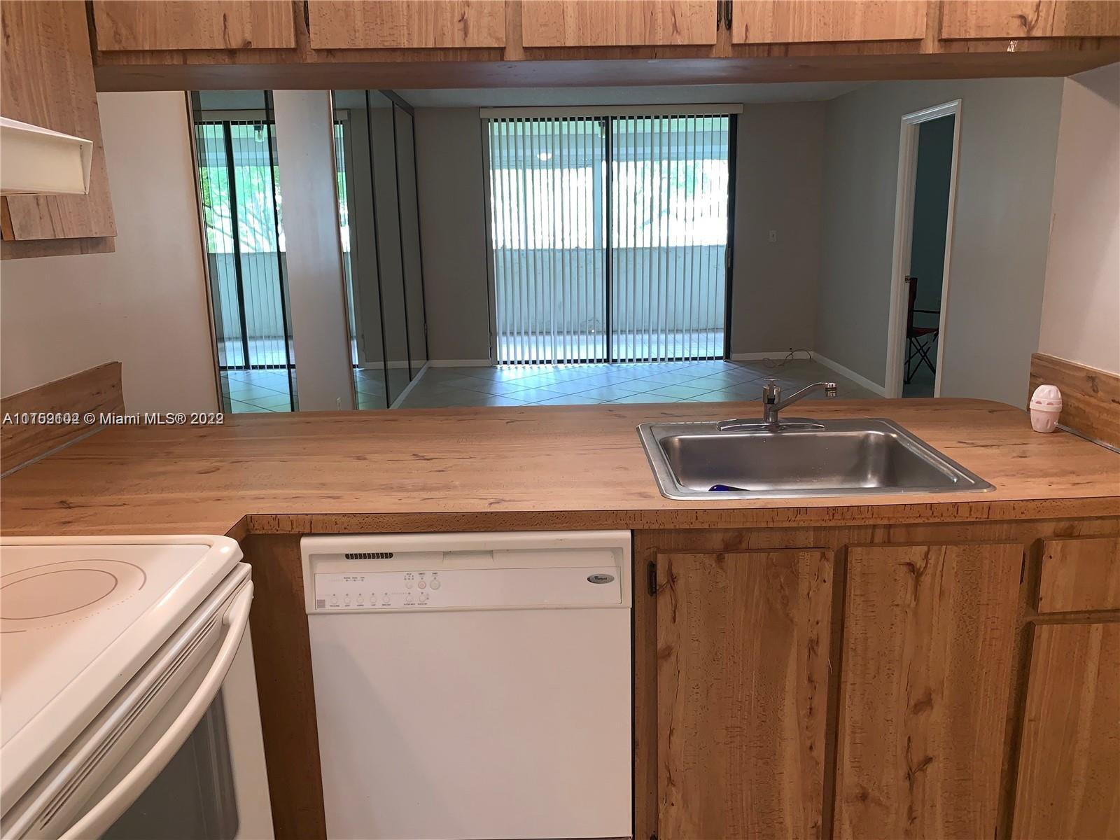 6800 Cypress Road, Unit 208 Plantation, FL 33317 - Photo 3 of 13 a utility room with a sink and a washer dryer