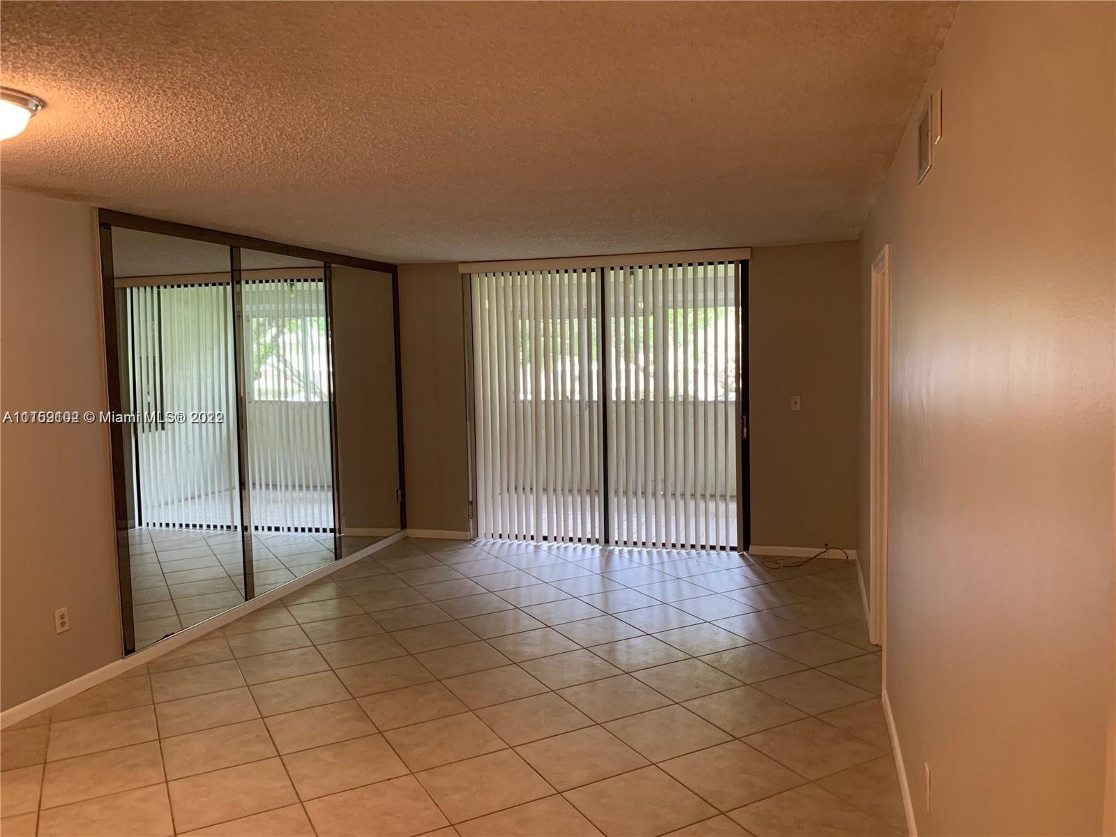 6800 Cypress Road, Unit 208 Plantation, FL 33317 - Photo 5 of 13 an empty room with sliding door and windows