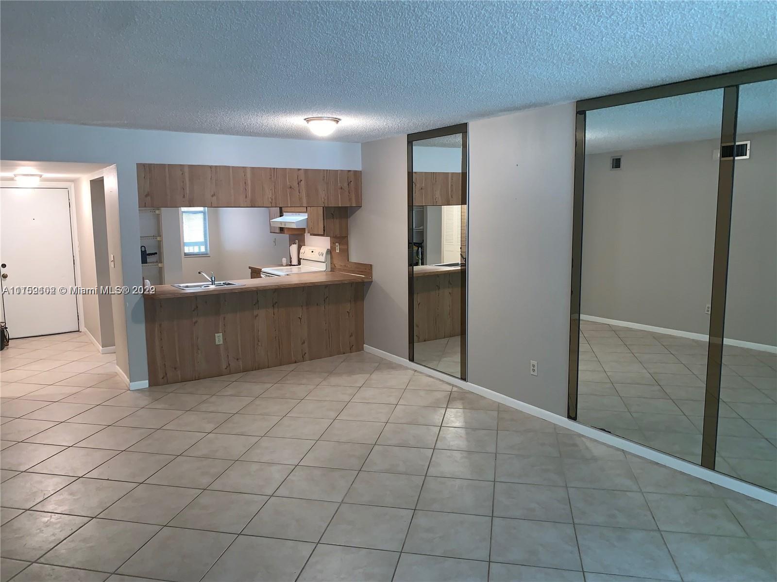 6800 Cypress Road, Unit 208 Plantation, FL 33317 - Photo 6 of 13 a kitchen with stainless steel appliances a refrigerator and a sink
