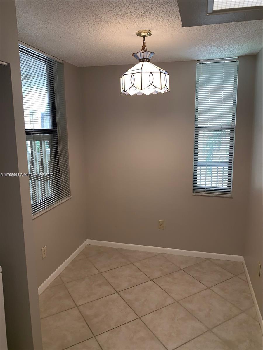 6800 Cypress Road, Unit 208 Plantation, FL 33317 - Photo 7 of 13 a view of an empty room with a window