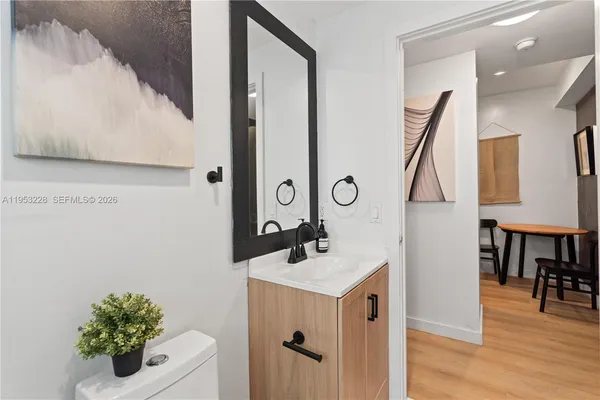 a bathroom with a sink vanity and a mirror