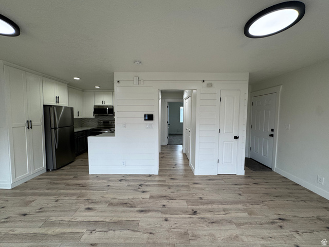 608 South 500 West, Unit 3 Provo, UT 84601 - Photo 6 of 35 Open-concept living area with wood-finish flooring, white walls, and contemporary ceiling lighting