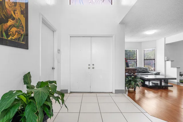 a hallway with a dining table and chairs