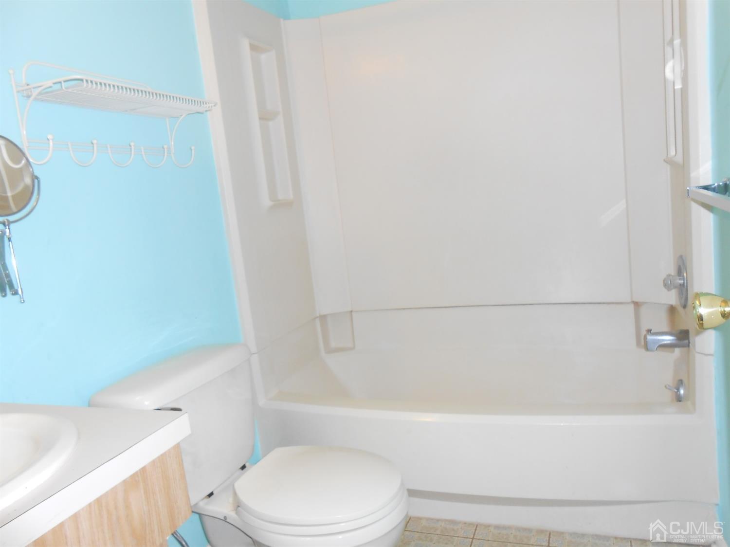 2 Rainford Road Edison, NJ 08820 - Photo 9 of 25 a bathroom with a bathtub and toilet