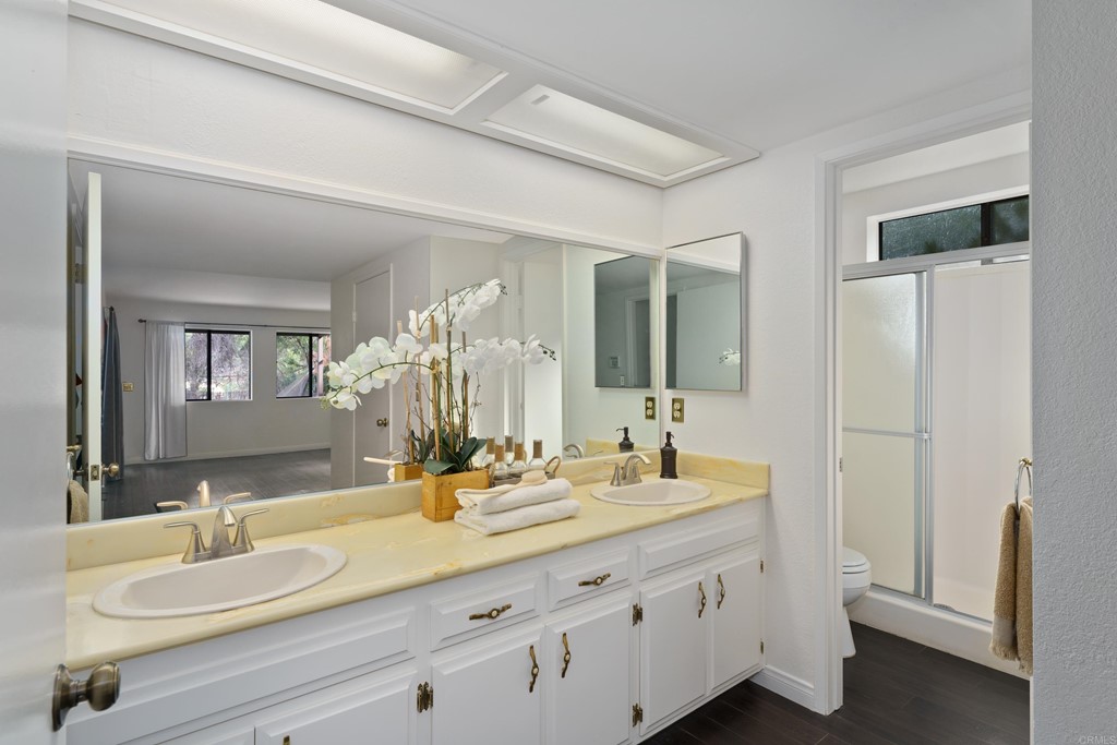 8764 Golden Ridge Road Lakeside, CA 92040 - Photo 22 of 62 a bathroom with a double vanity sink and a mirror