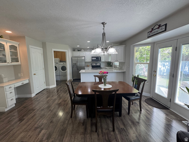 1976 River Bottom Road Springville, UT 84663 - Photo 15 of 45 Open concept living space featuring a dining area with wood-finish flooring, a kitchen with white cabinetry and stainless steel appliances, and a built-in desk area with glass-front upper cabinets
