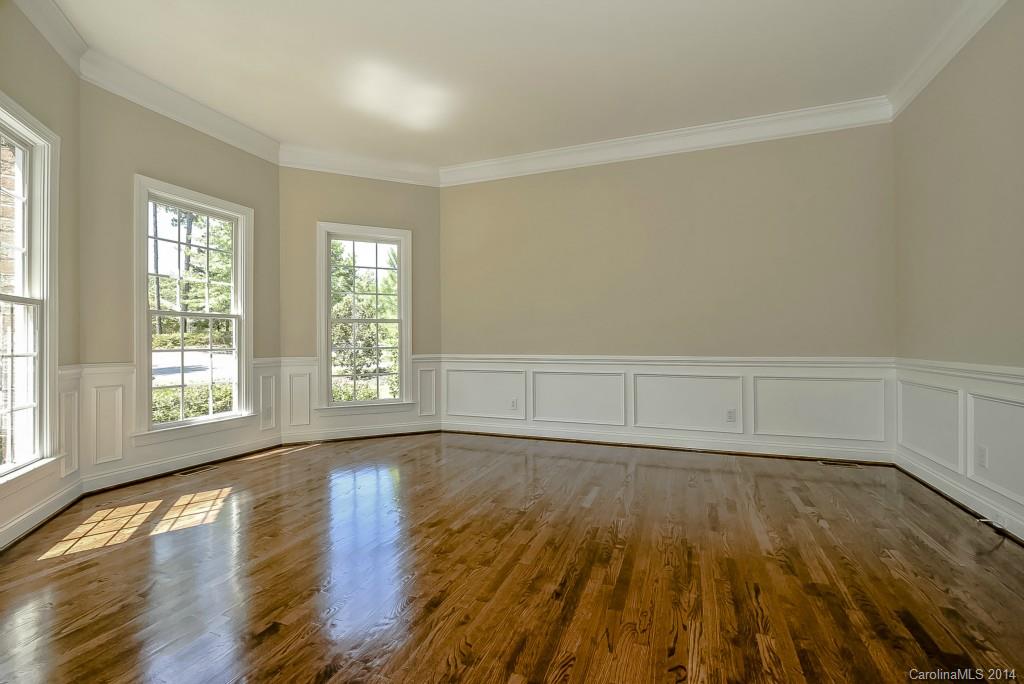 955 Cove Point Lane Tega Cay, SC 29708 - Photo 3 of 24 an empty room with wooden floor and windows