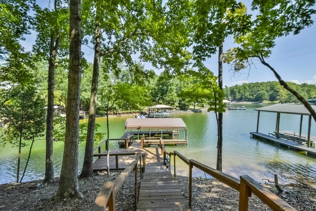 955 Cove Point Lane Tega Cay, SC 29708 - Photo 22 of 24 a view of a lake with a deck