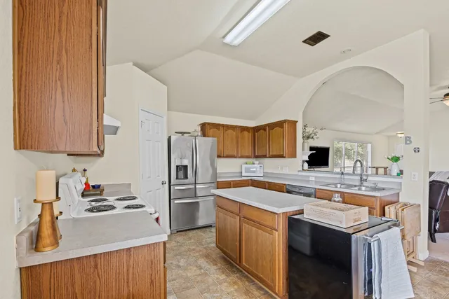 a kitchen with a sink appliances and cabinets