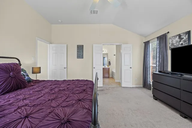 a bedroom with a bed and a television in it