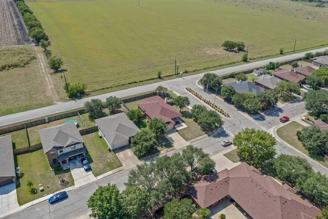 an aerial view of residential houses with outdoor space