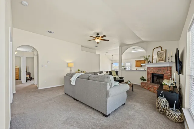 a living room with furniture and a fireplace