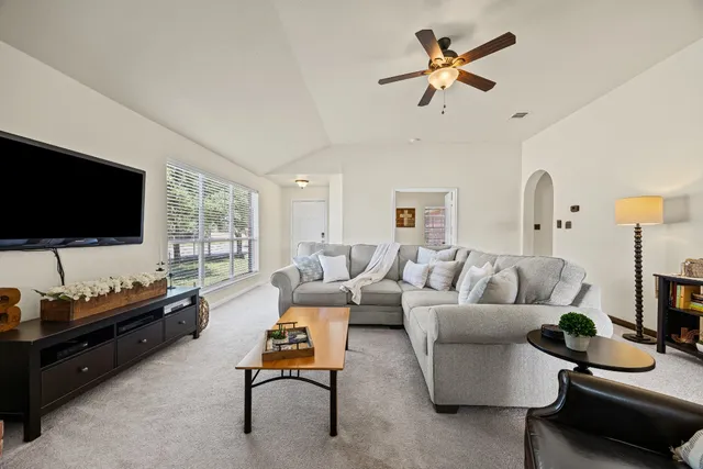 a living room with furniture and a flat screen tv