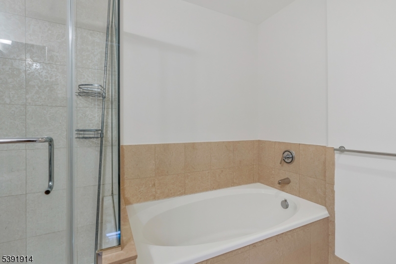 1 Spring Street, Unit 1704 New Brunswick, NJ 08901 - Photo 21 of 44 a bathroom with a bathtub and shower