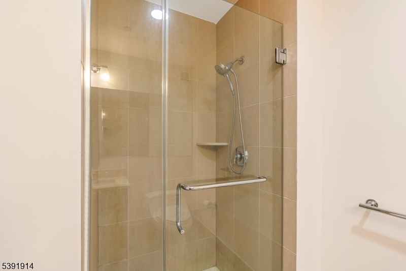 1 Spring Street, Unit 1704 New Brunswick, NJ 08901 - Photo 26 of 44 a bathroom with a glass shower door