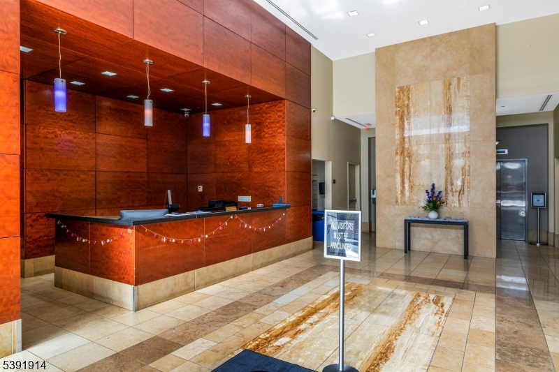 1 Spring Street, Unit 1704 New Brunswick, NJ 08901 - Photo 3 of 44 a view of a lobby with furniture and a rug