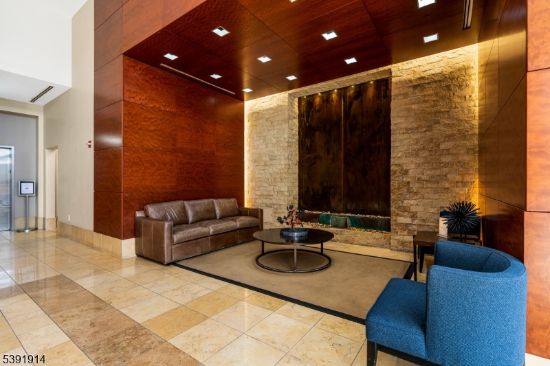 1 Spring Street, Unit 1704 New Brunswick, NJ 08901 - Photo 4 of 44 a outdoor living with furniture and a potted plant