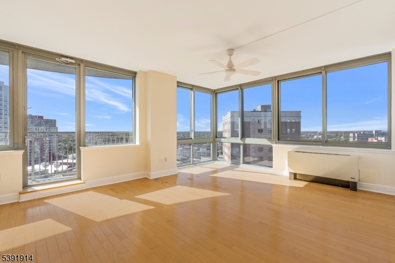 1 Spring Street, Unit 1704 New Brunswick, NJ 08901 - Photo 6 of 44 a large kitchen with kitchen island a large window a sink and cabinets