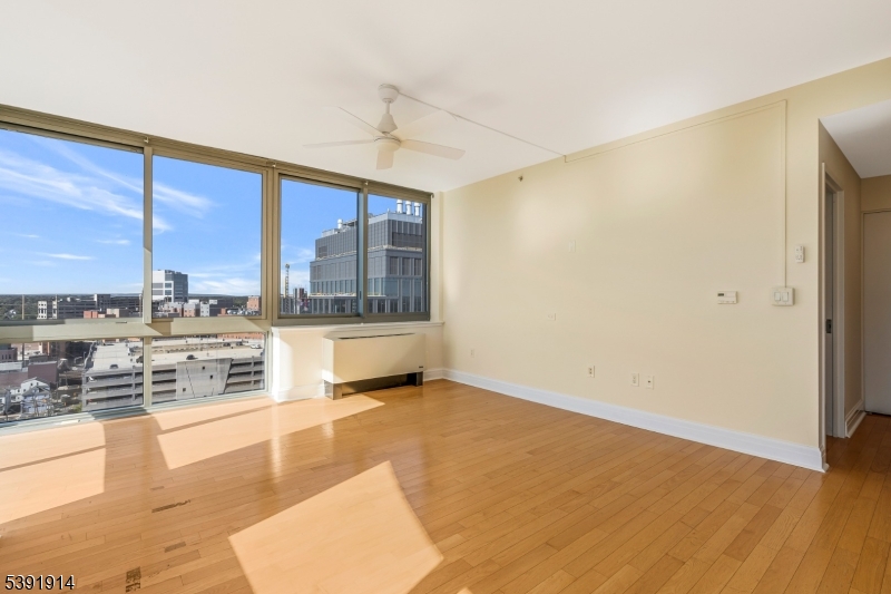 1 Spring Street, Unit 1704 New Brunswick, NJ 08901 - Photo 7 of 44 a view of a living room hardwood floor and a large window